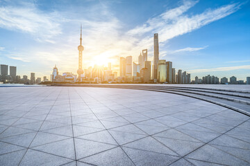 Empty square floors and modern city buildings scenery at sunrise in Shanghai. Famous city landmarks in Shanghai.