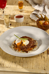 Beefsteak with an egg and white mushrooms, a rich and savory dish