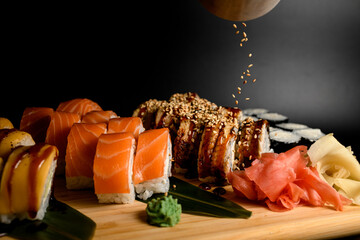 Set of philadelphia sushi rolls with eel, salmon and tuna and maki sprinkled with sesame