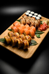 Top view of philadelphia sushi rolls with eel, salmon and tuna and maki with cream cheese