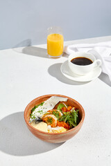 Elevated breakfast of scrambled omelet with shrimp, cheese mousse, and a side of coffee and orange juice