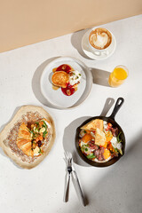 Gourmet Breakfast Spread with Croissant, Skillet Eggs, and Pancakes. Top view.