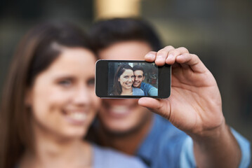 Portrait, selfie of happy couple and phone screen, love and care in relationship. Man, woman and profile picture of face on smartphone, memory or photo together on social media on valentines in home
