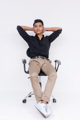 A poised young Filipino man sits back in an office chair, exuding a relaxed yet professional demeanor against a white background.