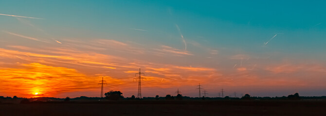 Sunset with overland high voltage lines near Aholming, Deggendorf, Bavaria, Germany