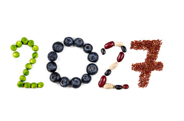 Happy New Year 2027 number made of fruits and vegetable on white