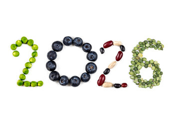 Happy New Year 2026 number made of fruits and vegetable on white
