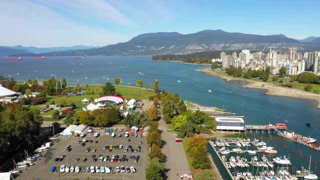 aerial drone fligh above vancouver bridge, marina and park, canada