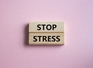 Stop Stress symbol. Concept word Stop Stress on wooden blocks. Beautiful pink background. Business and Stop Stress concept. Copy space
