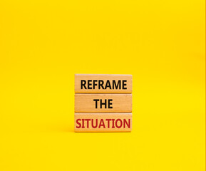 Reframe the situation symbol. Concept words Reframe the situation on wooden blocks. Beautiful yellow background. Business concept. Copy space.
