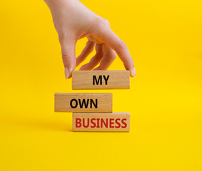 My own Business symbol. Concept words My own Business on wooden blocks. Businessman hand. Beautiful yellow background Business and My own Business concept. Copy space.