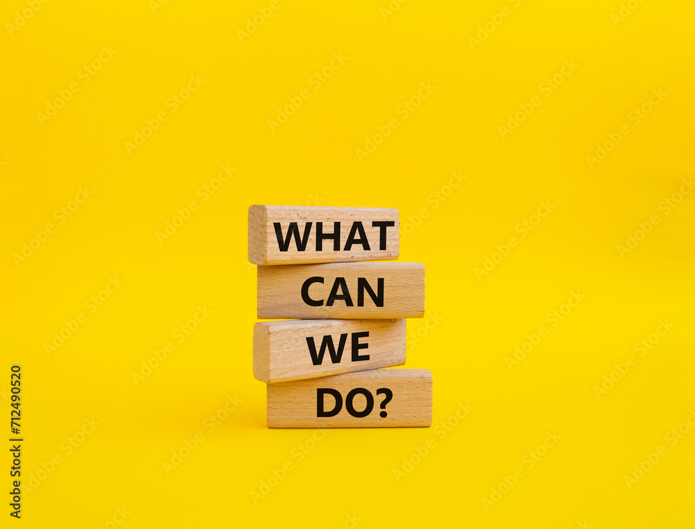 Wall mural what can we do symbol. wooden blocks with words what can we do. beautiful yellow background. busines