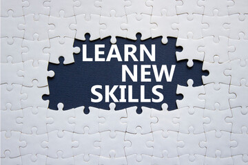 Learn new skills symbol. Concept words Learn new skills on white puzzle. Beautiful deep blue background. Business and Learn new skills concept. Copy space.