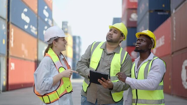 Group of professional dock worker and engineering people taking with their supervisor while record data online with digital connection tablet at Container cargo, Import and Export concept.