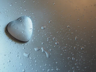 Heart shaped box on silver background with water drops for Valentine's Day