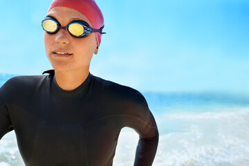 Sports, goggles and woman swimming at the beach with blue sky for triathlon, race or competition...