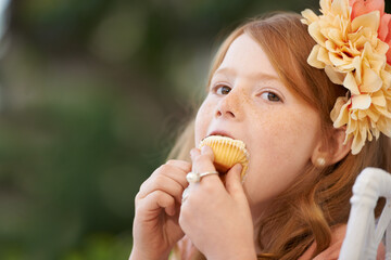Child, girl and eating cupcake or sweets for happy or birthday food or celebration, dessert or...