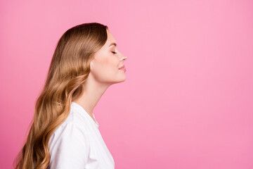 Side profile photo of adorable nice girl with curly hair dressed white t-shirt smell fragrant...