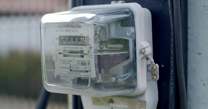 Electrometer measuring electricity consumption.Close-up front of a domestic electric meter and dial turning.