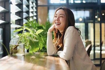 Smiling woman sitting in cafe’