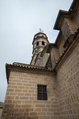 Fototapeta na wymiar Tower of the Baeza Cathedral, or in full the Cathedral of the Assumption of the Virgin of Baeza, in the province of Jaen, Spain. Its construction ended in 1593.