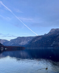 The beautiful view of Hallstatt Lake and its alpine mountain range, observed from the Hallstatt Skywalk island in Hallstatt, Austria.