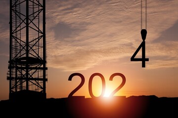 crane lifting 4 number to 2024 new year silhouette