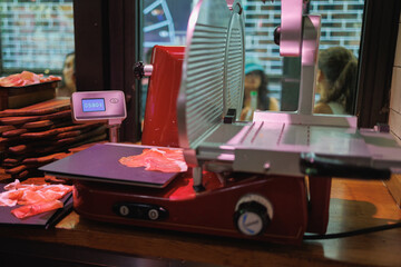 Manual Ham Slicer and Slices of Raw Ham