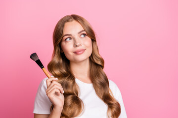 Fototapeta premium Portrait of dreamy cute girl with curly hair dressed white t-shirt hold brush look at sale empty space isolated on pink color background