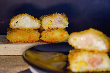 The Indonesian version of risoles or risoles is filled with mayonnaise, sausage, corn and boiled egg wrapped in a crepe-like wrapper and coated in breadcrumbs and deep-fried. selected focus.