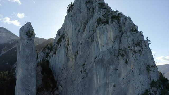 Aerial Ascending Upward Beautiful View Of Trees On Rock Formations During Sunny Day - Isere, France