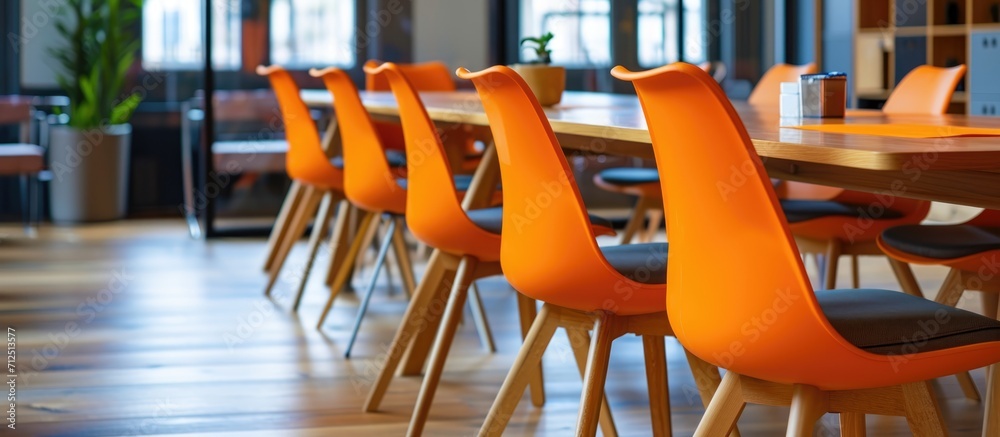 Canvas Prints Orange chairs and wooden conference tables in business meeting or board room interiors.