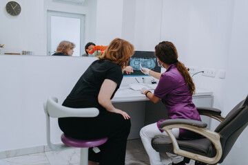 In a modern dental office, a dentist and a young patient engage in a collaborative consultation, exploring new tooth shades and discussing treatment options using a computer