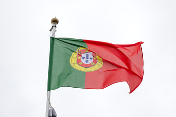 Flag of Portugal - Coimbra, Portugal. A large flag of Portugal flutters in the wind. Close-up. Great for news. Portugal flag on white background