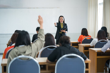 Education, teaching, learning concept. Asian university lecturer teaching lesson to students in classroom