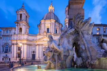 Close up view of the fountain of the four Rivers at illuminated Piazza Navona in blue hour before sunrise, Rome, Italy.