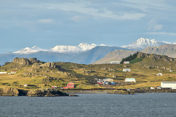The small town of Djúpivogur, Iceland, backed by dramatic, snow capped peaks.