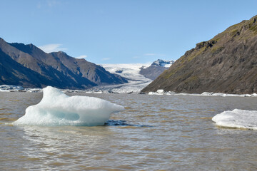 Small icebergs float in a glacial lake, having broken off from Vatnajokull glacier, Iceland