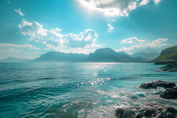 The image shows a large body of water with mountains in the background. The water is blue and clear, and the mountains are green and snow-capped.