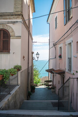 Scenic view of an alley with the sea behind