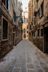 Naklejka na ściany i meble Looking down the narrow streets or alley of Venice