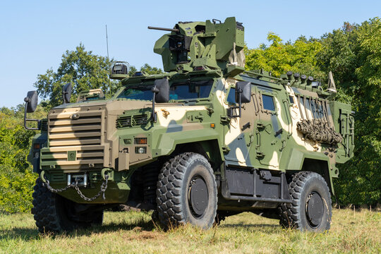 A camouflaged modern 4x4 MRAP armored fighting vehicle