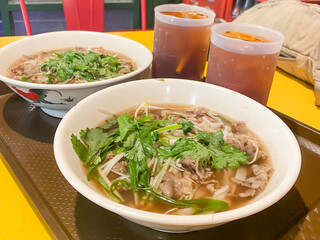 Pho is Vietnamese soup dish consisting of broth, rice noodles, herbs, and beef pork chicken meat. Typically served with scallion, onion and cilantro (coriander leaves), bean sprouts, lime, chili oil.