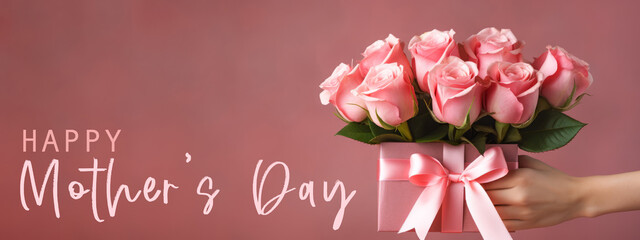 Happy Mother's Day concept celebration holiday greeting card banner background  - Girl holding a present gift box with pink bunch bouquet of roses flowers in her hands