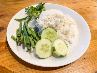 A plate of White Rice with Lalapan. Lalap is fresh raw vegetables served with sambal or chili sauce. Concept for extreme diet.