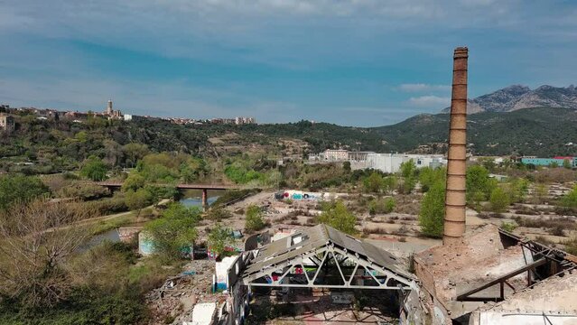 Old chimney in abandoned area. Ascending drone shot, Olesa de Montserrat