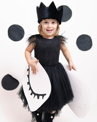 joyful child in a dress on a white background
