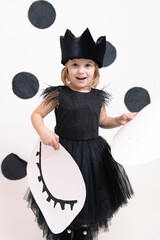 joyful child in a dress on a white background