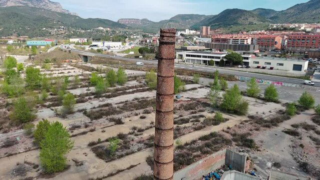 Old chimney in abandoned area. Ascending drone shot, Olesa de Montserrat