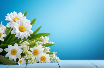 Bouquet of spring flowers of daisies and lilies of the valley on a table on a blue background